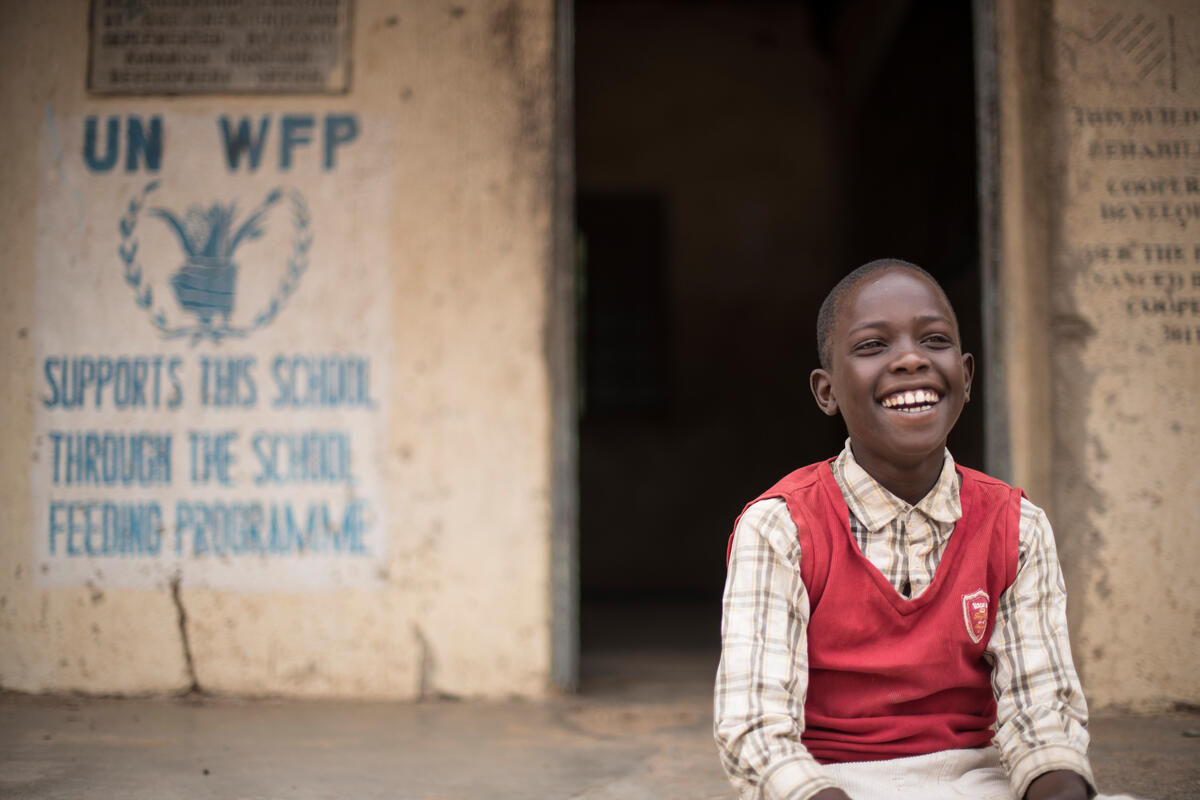 boy in front of a school. 