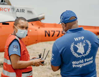 Antonio Beleza, National Institute for Disaster Management and Risk Reduction (INGD) (left) and Domingos Reane, World Food Programme, conduct a drone assessment in the wake of tropical storm Eloise. Photo: Mercy Air/Matthias Reuter.