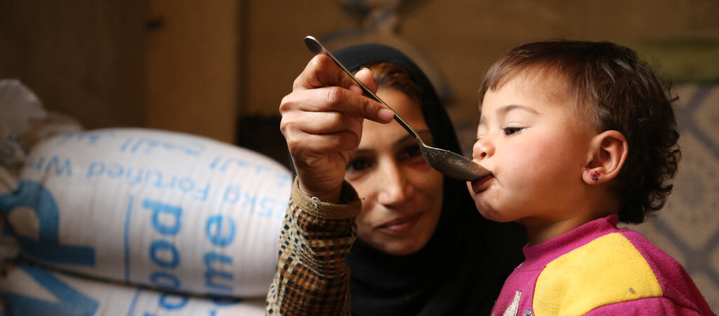 Syrian mother feeding child