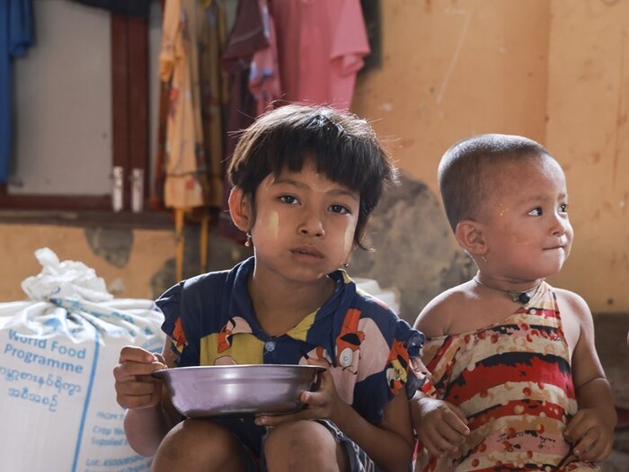 A family from Sittwe township, Rakhine State enjoys lunch with food assistance provided by WFP in the immediate aftermath of Cyclone Mocha.