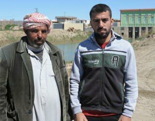Mitib Ibrahim (L) and Mohammed Jama'a (R) are from different tribes and got to know each other working together on the rehabilitation of an irrigation canal in Ramadi. Photo: WFP/David Orr