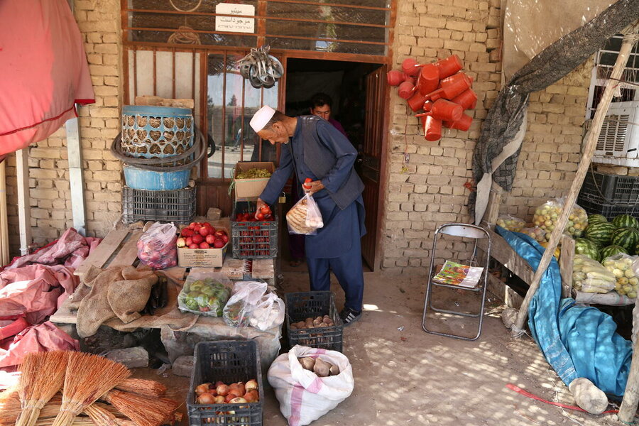 Afghan man choosing food outside shop