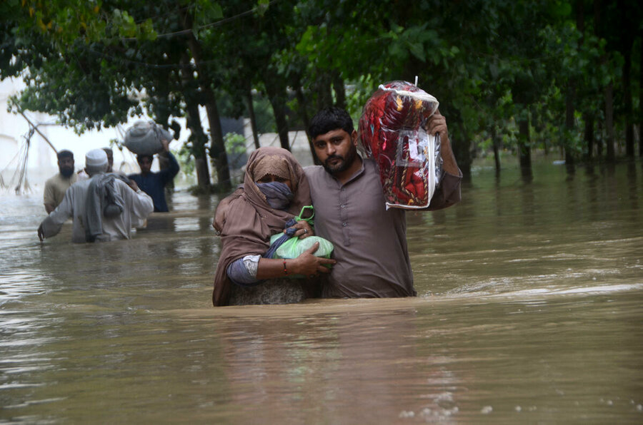 A couple in a flooded Peshawar street