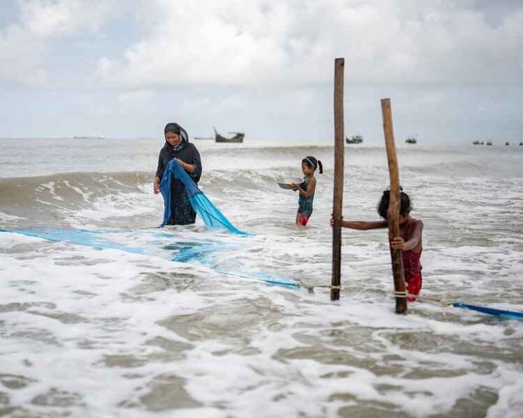 family fishing with nets in the sea in Bangladesh