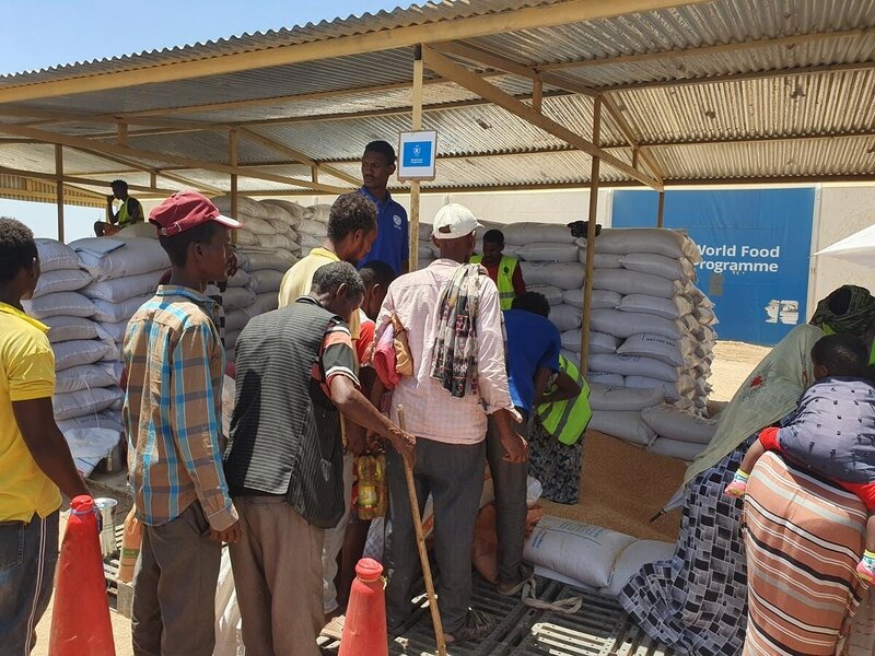 Refugees from Ethiopia's Tigray region queue for food assistance in Sudan