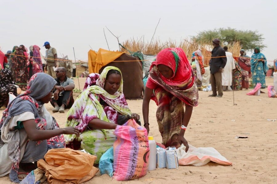 In Chad, women displaced by Sudan's crisis check out their newly collected WFP food. Photo: WFP/Jacques David