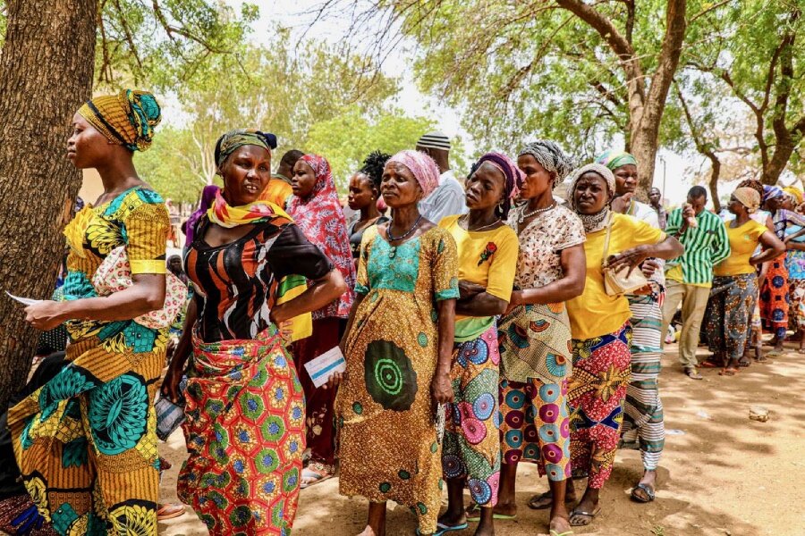 Displaced women line up for WFP cash assistance in Togo's Savanes region. Photo: WFP/Richard Mbouet