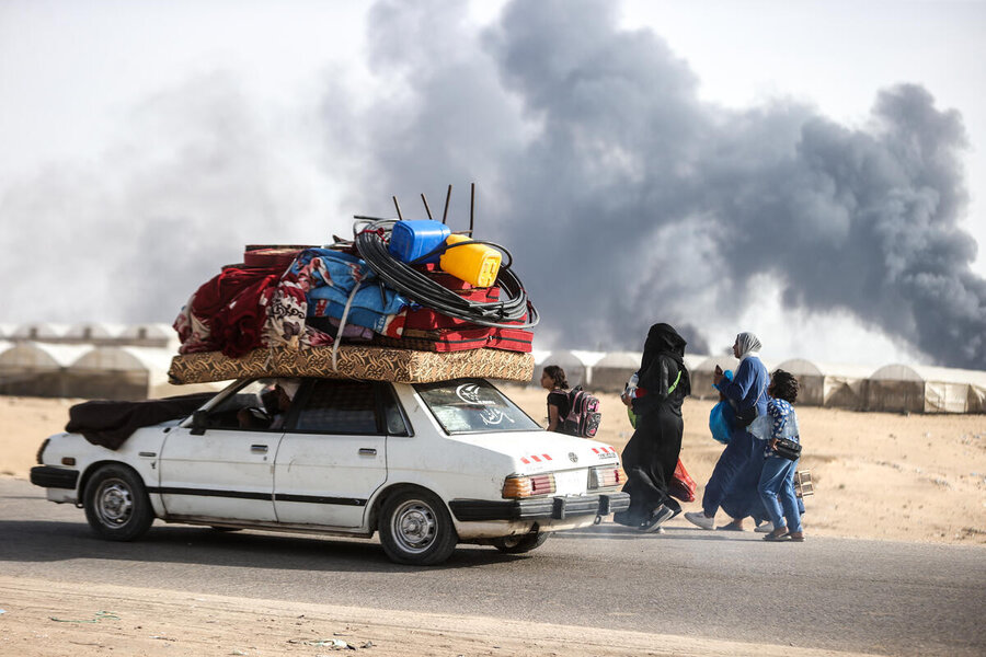 A vehicle makes its ways out of Rafah packed with belongings