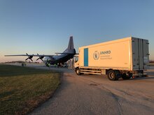 Camion ed aereo sulla pista della base logistica di Brindisi.